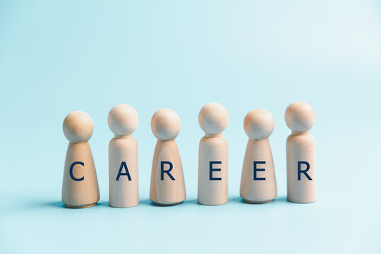 Career development concept with wooden people spelling CAREER on blue background, representing professional growth, employment, workforce planning, job opportunities and future goals.