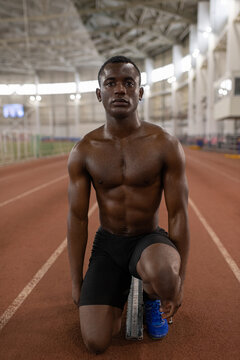 African American sportsman preparing to start run