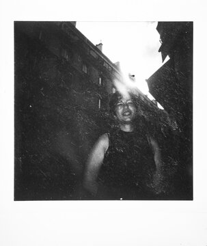 Woman laughing against Paris city buildings