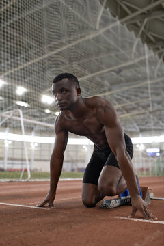 Black athlete ready to run on stadium
