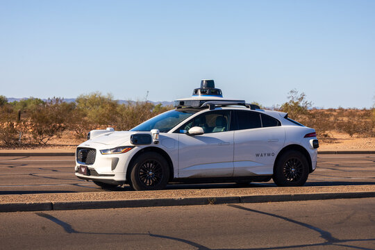 Waymo Autonomous Vehicle Driving in Phoenix, Arizona with Desert Landscape