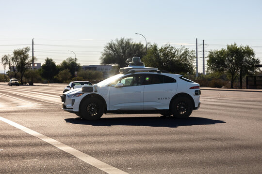 Waymo Autonomous Vehicle Driving in Phoenix, Arizona with Desert Landscape