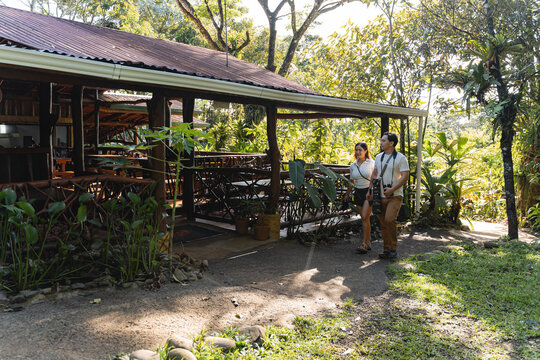 Visitors exploring eco-lodge resort in tropical rainforest