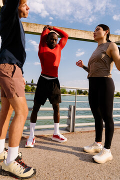 Fitness enthusiasts stretching before a morning park run.