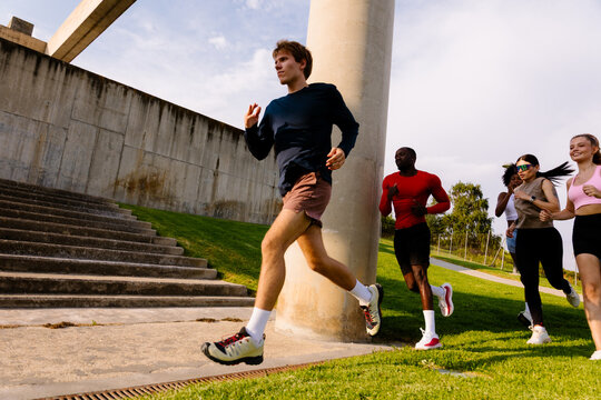 Wide-angle shot of sports club members training at dawn.