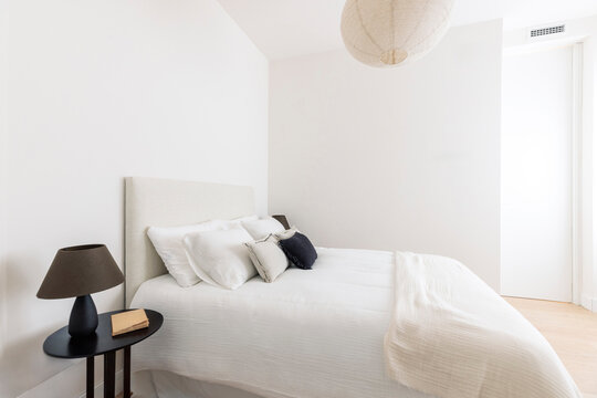 Bright bedroom with paper pendant