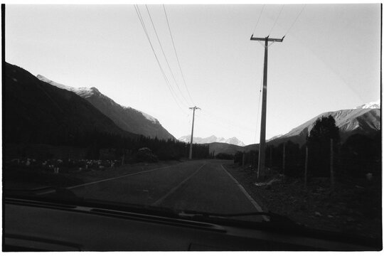 Empty road leading toward mountain ridge