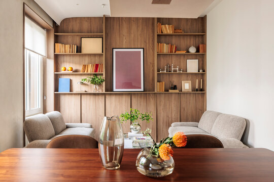 Symmetrical living room with wooden bookcase