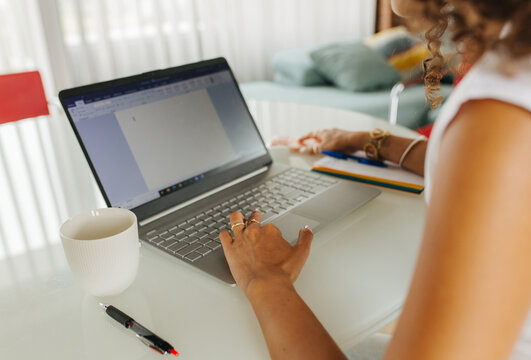 Hands Typing Document On Laptop