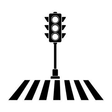 Black and white traffic light standing at a pedestrian crosswalk with striped road markings.