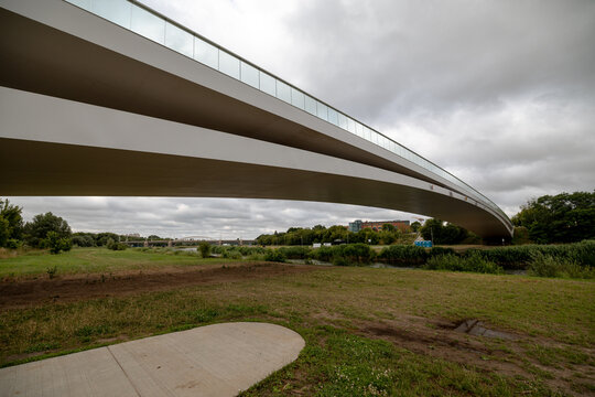 Poznan, Poland - July 8, 2026: The modern Berdychowskie Bridge forms sweeping lines above the Warta River floodplain.