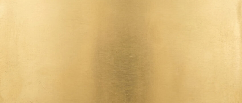 Smooth polished brass plate texture. Golden metallic background with ambient highlight