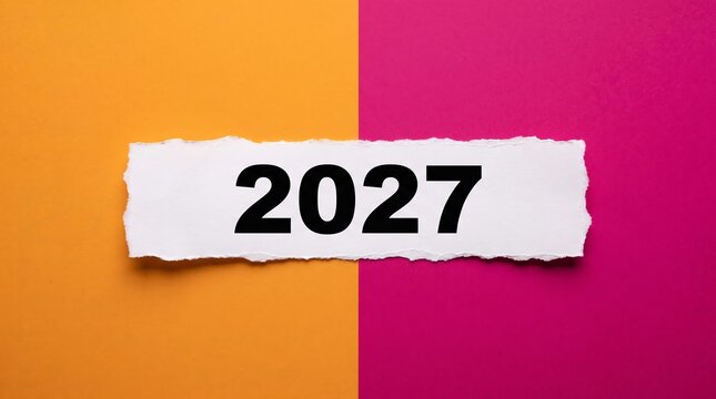 Bold 2027 lettering printed on white torn paper strip positioned horizontally across vibrant orange and bright pink split color background