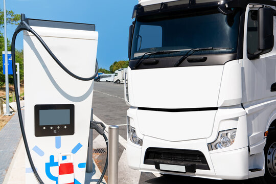 Electric truck next to EV charging station