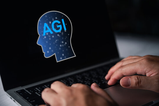 Artificial general intelligence AGI head icon above laptop with hands typing for machine intelligence research and future computing concept
