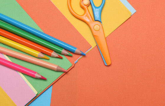 Colored pencils, paper, and scissors. Children's art. Flat lay
