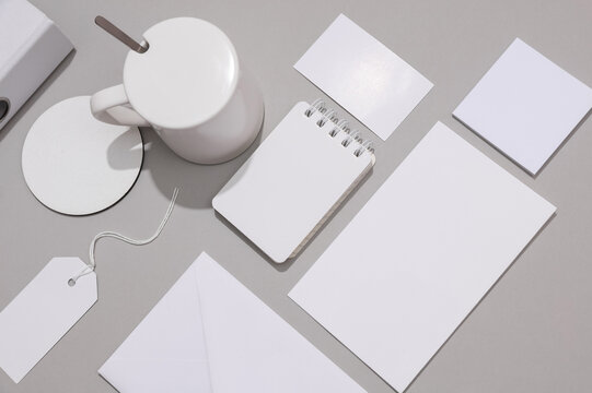 Corporate identity, set of white blank promotional products for business on a gray background. Flat lay. Creative mockup for your brand design.