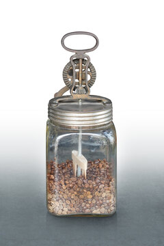 front view antique manual  repurposed or stored with coffee beans in glass cup on grey marble floor, white background, object, decor, keep, coffee, copy space