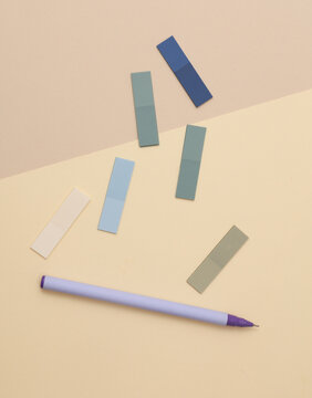 Set of colored paper stickers and pen on pastel background. Business concept.