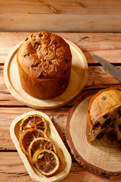 Chocolate panettone for Christmas celebrations, arranged on a rustic table with decorative elements.