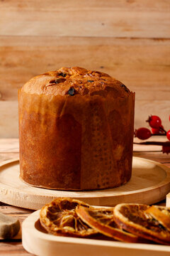 Handmade chocolate filled panettone served on a rustic wooden table with Christmas decorations