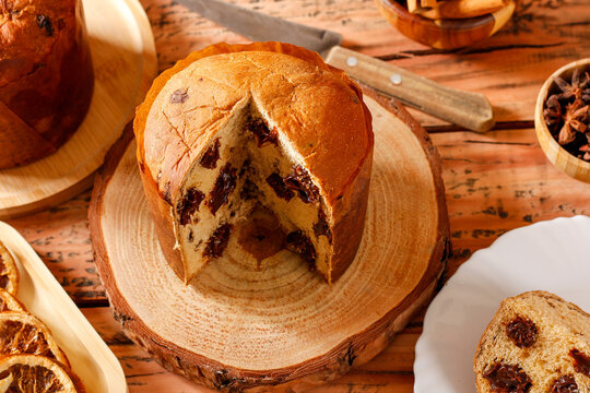 Chocolate Christmas panettone featured on a rustic table set for a family celebration.