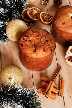 Artisanal Christmas chocolate panettone on a rustic wooden table decorated for the Christmas celebration