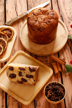 Chocolate panettone served during Christmas festivities on a rustic wooden table with traditional decorations.