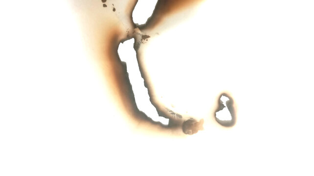 Burnt paper edge hole texture with scorch marks and charred border isolated on clean white background for vintage design overlay effect