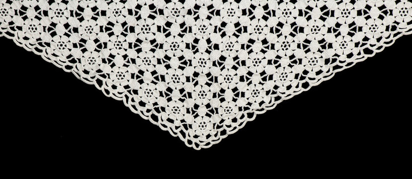 Crochet lace patterns border, crocheted Grandma's Doily corner, detail of hand-crocheted embroidery, tablecloth, napkin isolated on black background border art design. Craft, vintage linen. Flat lay