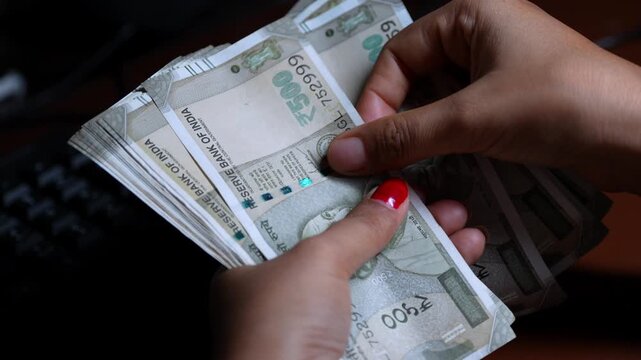 Hand counting Indian 500 rupee currency notes