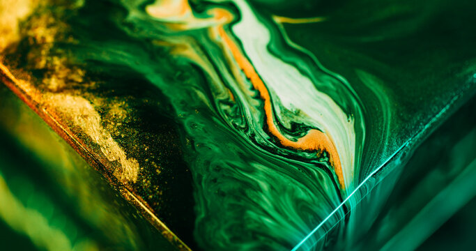 Shiny ink. Acrylic flow. Defocused green yellow neon color mix sparkling texture glitter fluid floating on abstract art background.