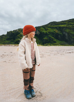 Child girl tourist walking on sandy beach in northern Norway family travel outdoor hiking vacations active lifestyle, adventure nature exploration eco tourism scandinavian destination childhood
