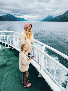 Mother and daughter traveling by ferry in Norway enjoying cold fjord and mountain views family vacations cruise tourism, Scandinavian adventure outdoor active lifestyle and scenic voyage together