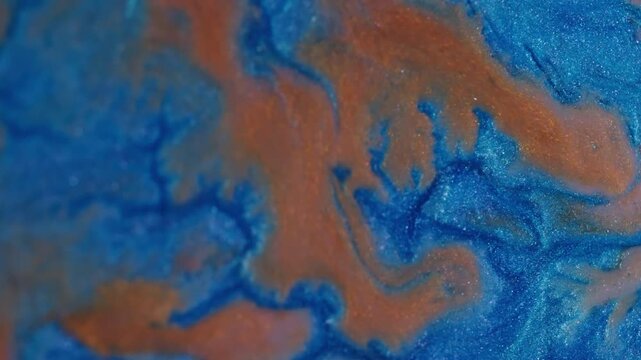 Paint spatter. Spill texture. Defocused orange blue colorful blend particles acrylic liquid floating on abstract creative background.