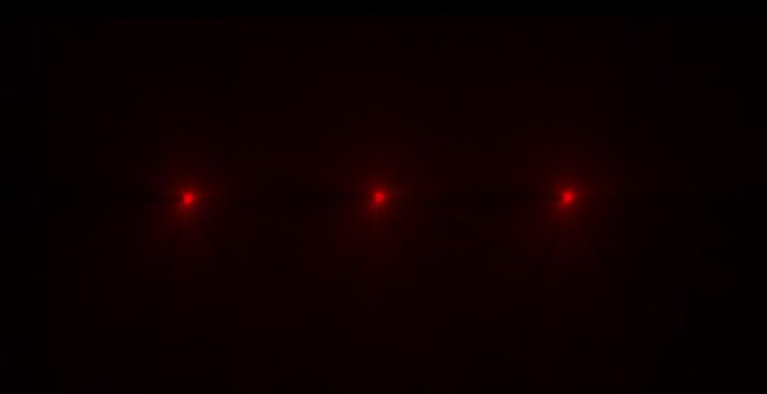 Abstract loop center glow multicolored star optical lens flares shine light animation on black background. 4K dynamic kinetic bright star light rays ..`