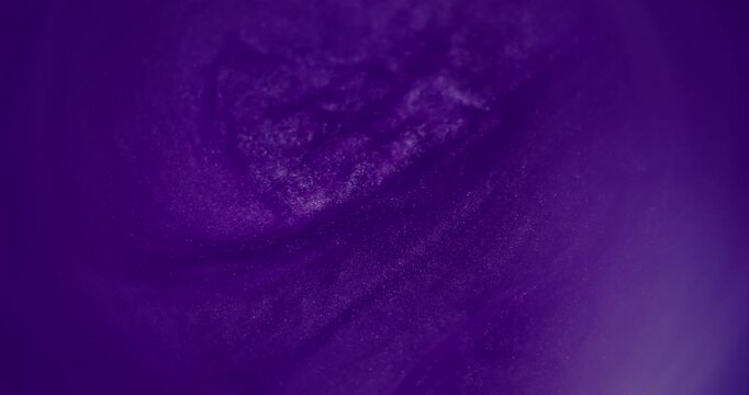 Blur shimmer dye. Glitter purple stream. Blue color acrylic pigment ink water shiny fluid rainbow texture spreading on abstract background.