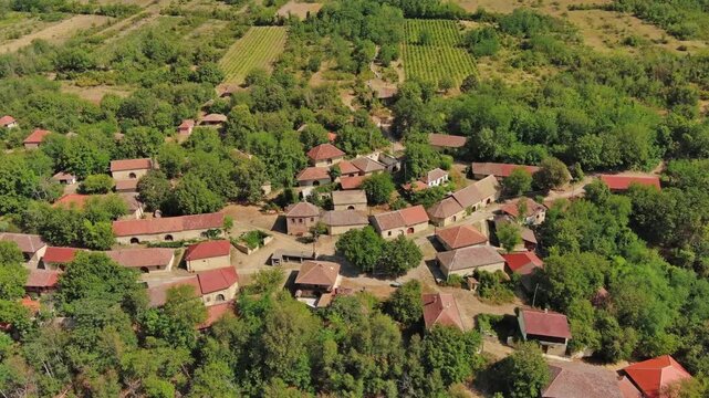 Aerial around view of old rustic vintage houses with wine cellars in Rogljevacke pivnice in Negotin region of Serbia, 4k