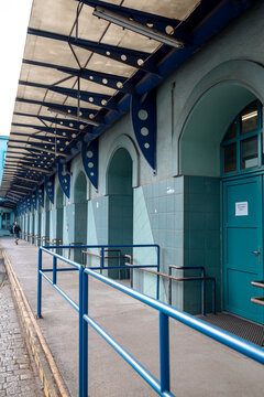 Wroclaw, Poland - July 10, 2026: Historic railway service building near Wroclaw Glowny forms an enclosed courtyard with rows of windows above a covered loading platform.