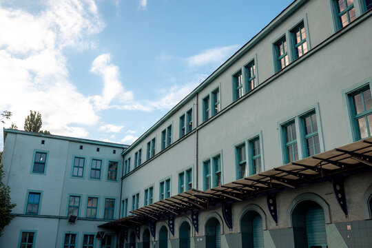 Wroclaw, Poland - July 10, 2026: Historic railway service building near Wroclaw Glowny forms an enclosed courtyard with rows of windows above a covered loading platform.