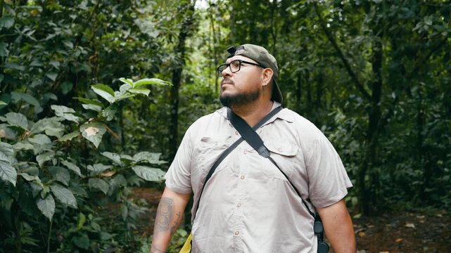 Tourist looking around with curiosity in the dense jungle of Arenal Volcano National Park. Explorer enjoying the biodiversity of nature