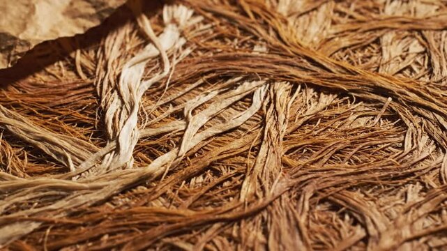 Close up view of natural fibrous material with rough texture and varying shades of brown