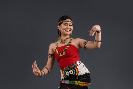 Smiling Sabahan Woman Wearing Traditional Murut Tahol Simba Costume Posing with Dance Gestures