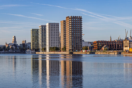 Antwerp, Belgium: Modern residential towers and apartment buildings located in the redeveloped Eilandje dockland district of Antwerp, reflecting beautifully in the calm basin water.