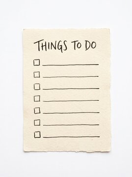 Handwritten things to do checklist on textured paper against white background