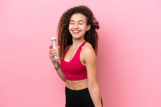 Young Sport Arab woman isolated on pink background