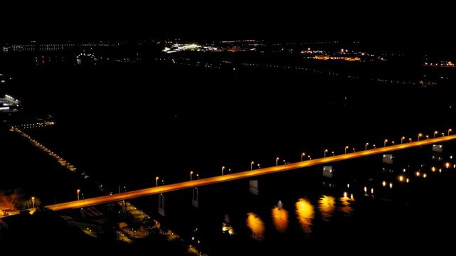 Perm, Russia. Night flight. Bridge over the Kama river - Komunalny bridge. Translated Text - Water Between Us. Drone footage, Point of interest