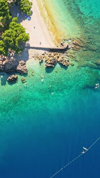 Vertical aerial view of Punta Rata beach and turquoise sea in Brela Croatia