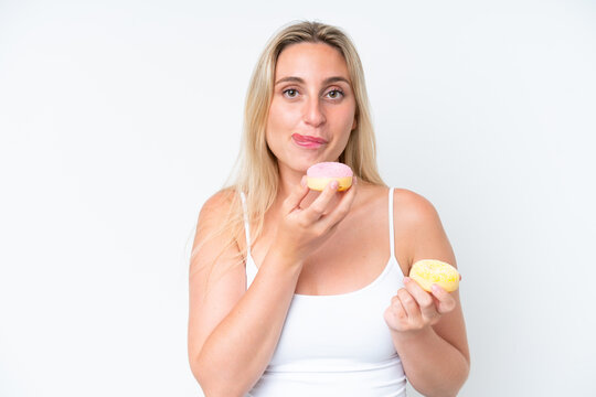 Young caucasian woman isolated on white background holding a donut