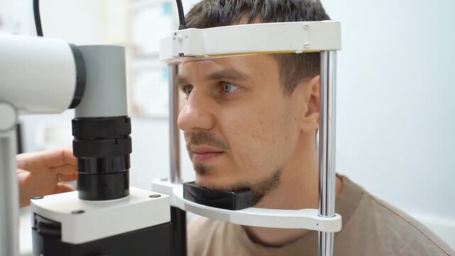 An ophthalmologist evaluates a patient's vision using medical equipment. Vision check.